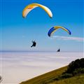 Two Hang gliders over beachy head sussex england showing a sea mist